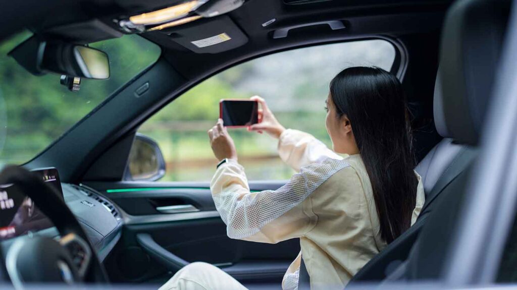a woman in a car taking picture of outside