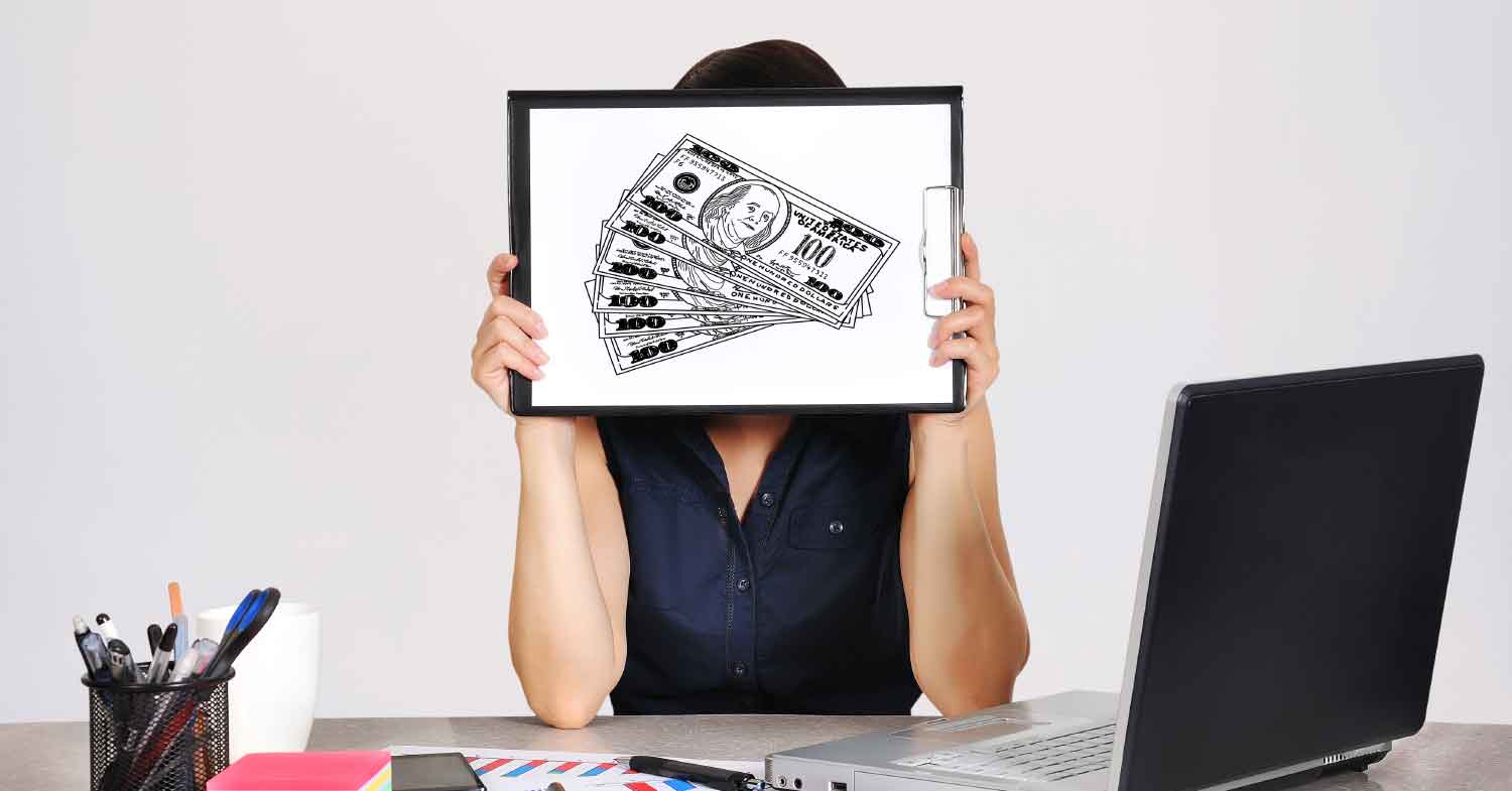women in front of her lap top holding a money picture