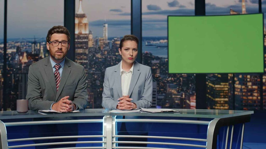 men and women on a breaking news report with a green screen TV